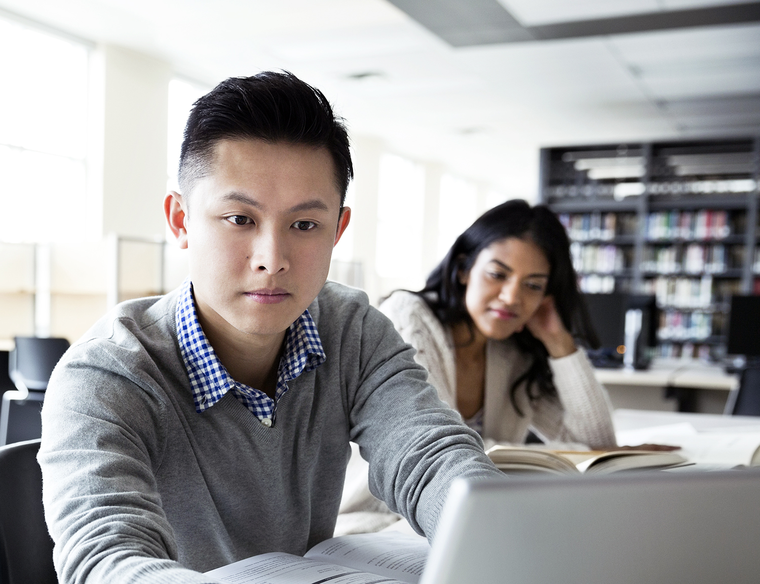 Student using laptop in college library