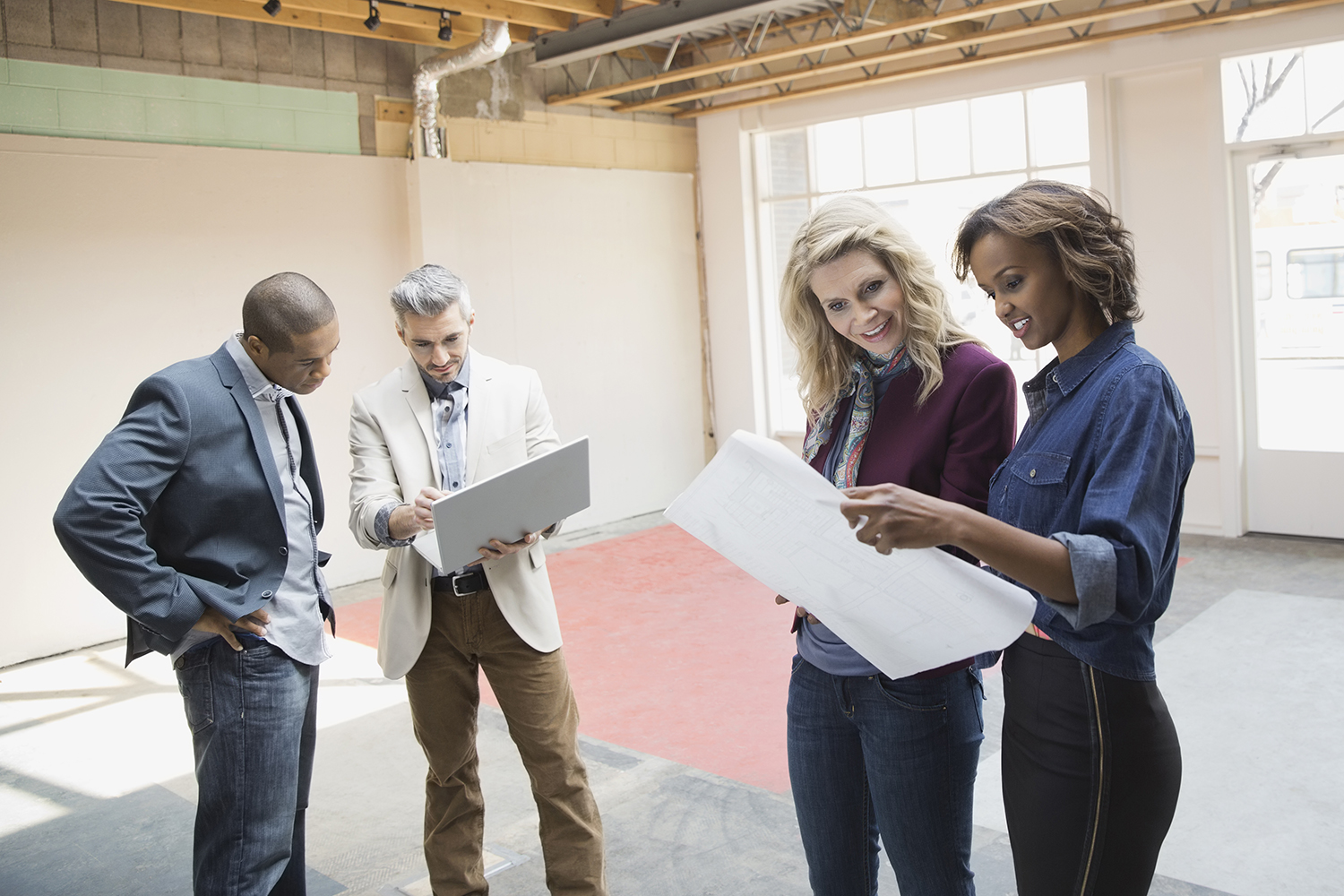 Business people reviewing blueprint in new office