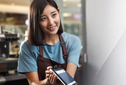 Cafe cashier using card machine.