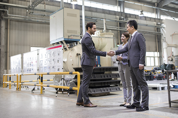 Business people shaking hands in the factory