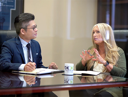 DKKD Staffing CEO Diane Krehbiel-Delson speaking to a Cathay Bank banker in a business meeting