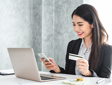 Young asian businesswoman in suit using smart phone and credit card for online shopping, internet banking and buying service from the internet.