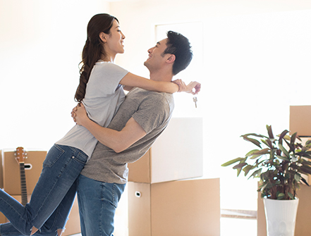 Happy young couple moving to a new house