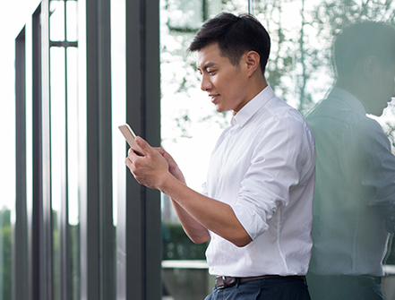 Young businessman using smart phone.