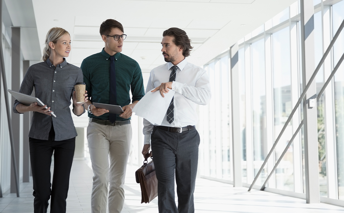 Business people walking in office corridor