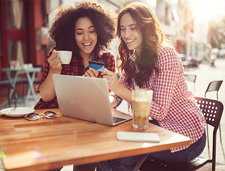 Girls drinking coffee and shopping online.