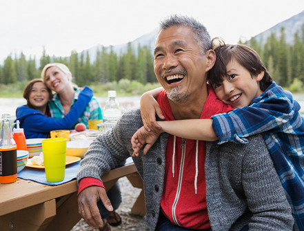 Family relaxing together at campsite.