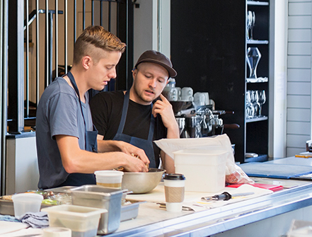 Chefs talking in restaurant kitchen