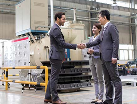 Business people shaking hands in the factory