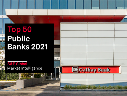 Top 50 Public Banks by S&P Global Market logo sits on the image of the Cathay Bank headquarters building in El Monte, California 