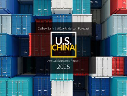 A 2025 US-China UCLA Anderson Forecast logo floats over shipping containers off a U.S. port.