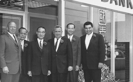 Six of the seven founding members of Cathay Bank posing in front of Cathay Bank’s first location