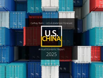A 2025 US-China UCLA Anderson Forecast logo floats over shipping containers off a U.S. port.