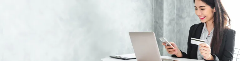 Young asian businesswoman in suit using smart phone and credit card for online shopping, internet banking and buying service from the internet.