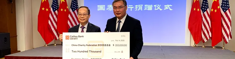 Pin Tai (left), Chief Executive Officer of Cathay Bank, presented donation check to Zhang Ping (right), the Consul General of the Consulate General of the People's Republic of China in Los Angeles, in support of the coronavirus control efforts in China.