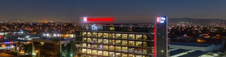 Cathay Bank’s corporate center building stands tall against the night sky in San Gabriel Valley.