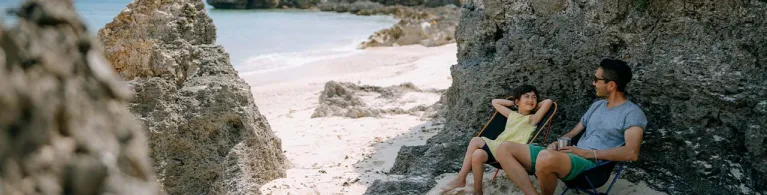Father and young daughter having fun at beach campsite