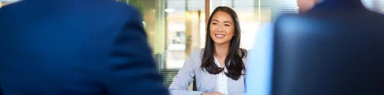 Woman in an office smiling.
