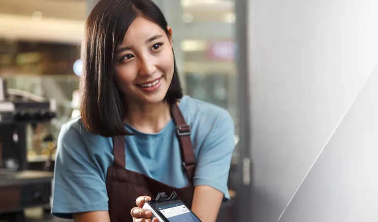 Cafe cashier using card machine.