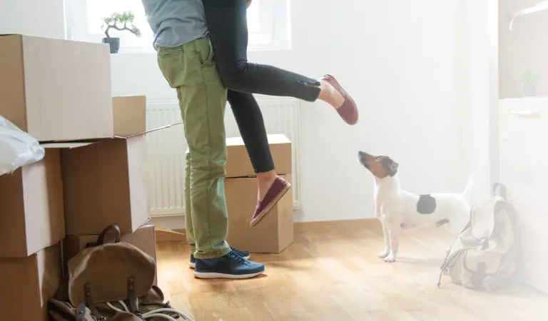 Happy man lifting woman in new house 