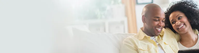 Couple using digital tablet together