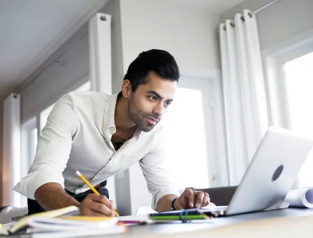 Architect working at laptop on dining table