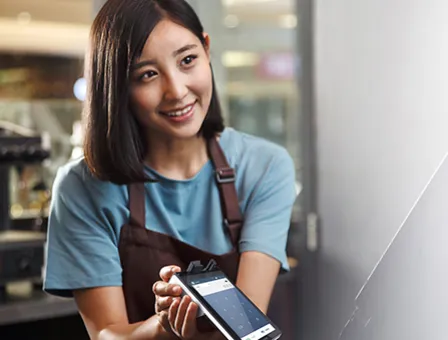 Cafe cashier using card machine.