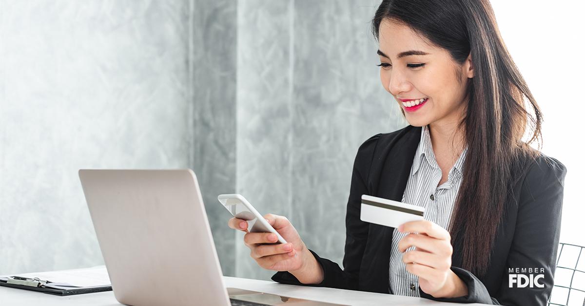 Young asian businesswoman in suit using smart phone and credit card for online shopping, internet banking and buying service from the internet.
