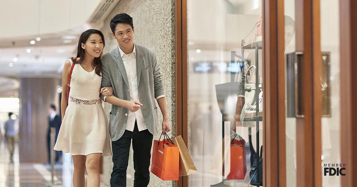 Happy couple window shopping in luxury mall