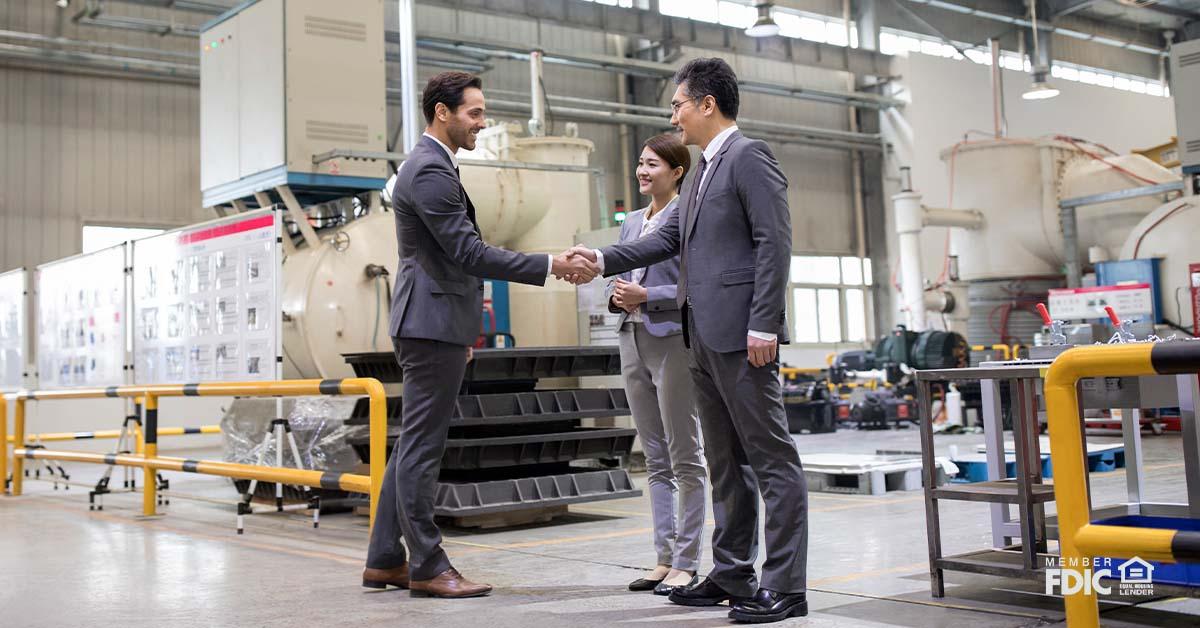 Business people shaking hands in the factory
