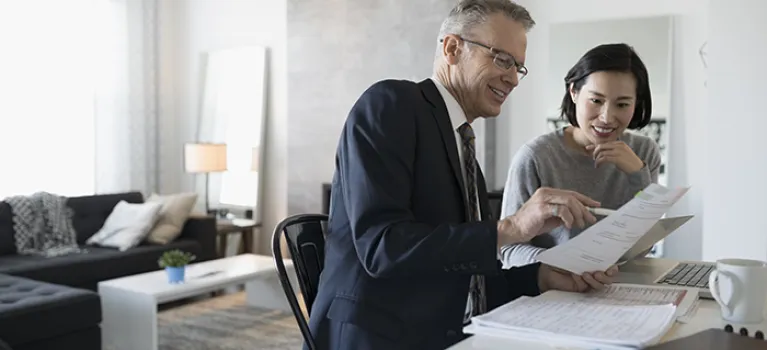 Financial advisor presents customer plans in house.