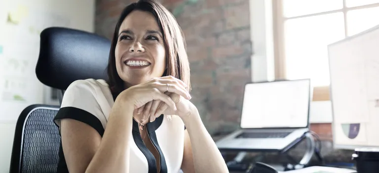 Smiling businesswoman at office desk