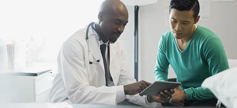 Doctor and patient looking at digital tablet
