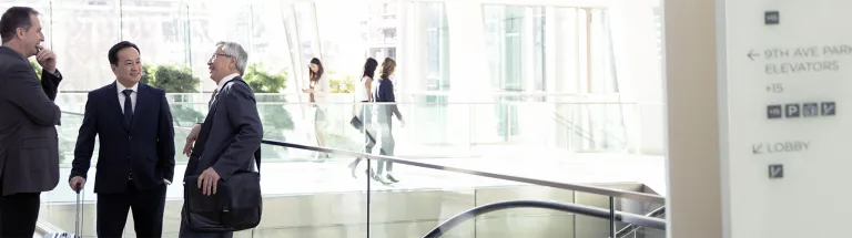 Businessmen talking in airport atrium