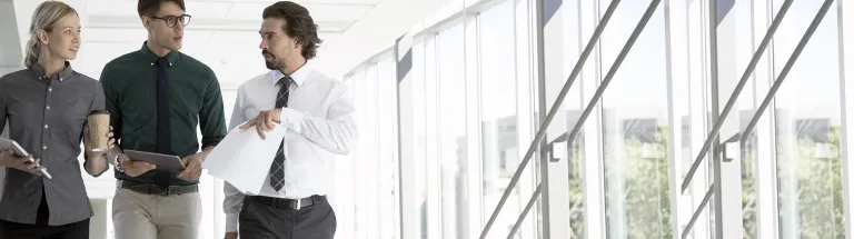 Business people walking in office corridor