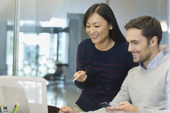 Business people working on laptop in office.