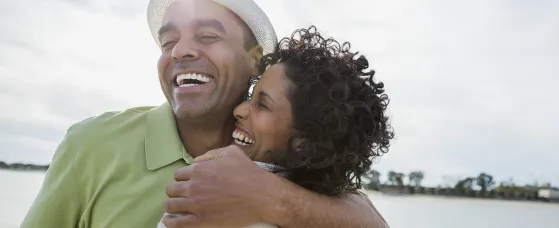Loving mature couple embracing on beach