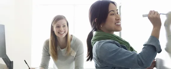 Female students working in classroom at college campus