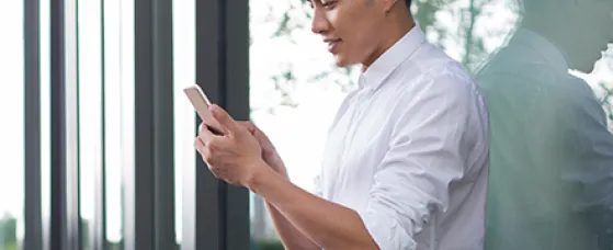 Young businessman using smart phone.