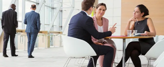Business people discussing plans in a lobby.