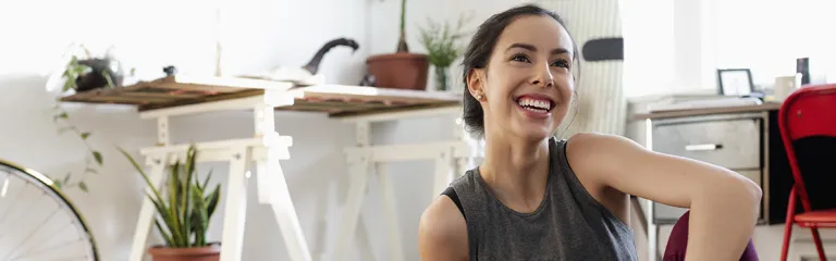 Happy young woman practicing yoga at home