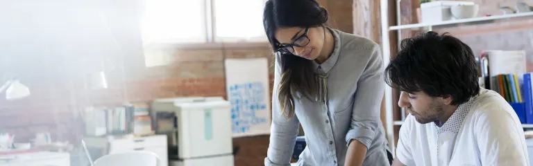 Designers reviewing and discussing plans in office