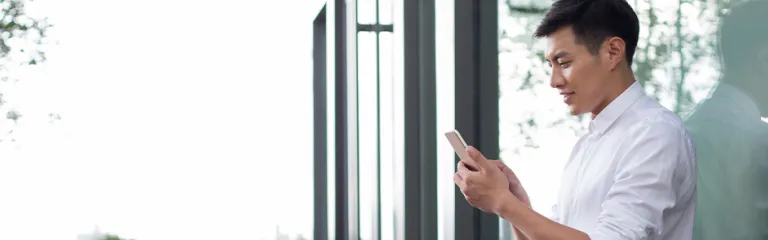 Young businessman using smart phone.