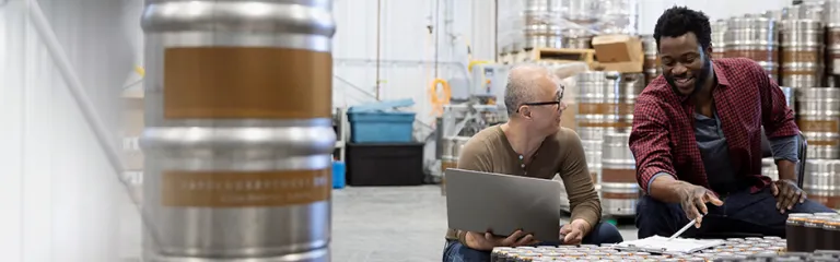 Two staff working in warehouse