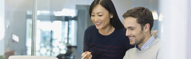 Business people working on laptop in office.
