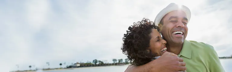 Loving mature couple embracing on beach