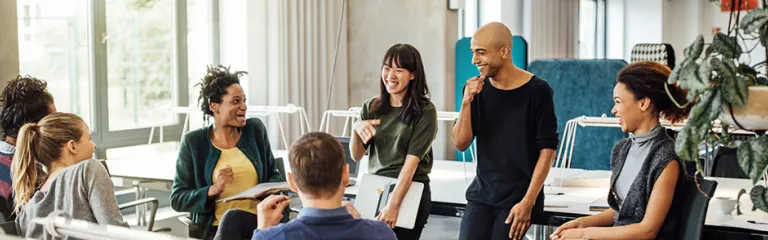 Happy multi-ethnic people discussing at office 