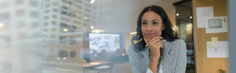 A young architect looking away at desk