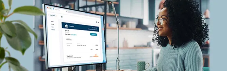 A businesswoman using her Autobooks service to email an invoice to her client.